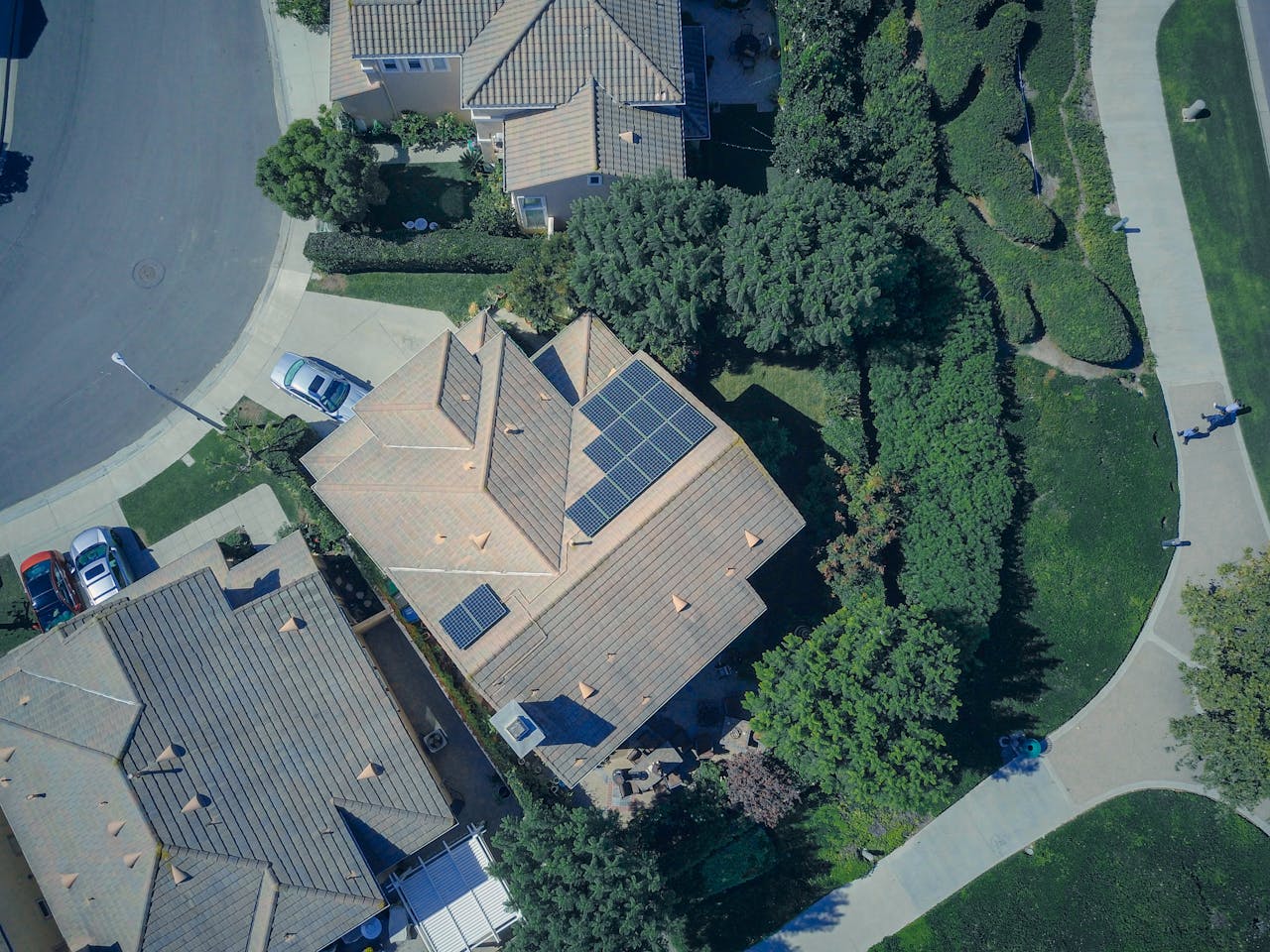 Crafting Captivating Headlines: Your awesome post title goes here An aerial view showcasing modern suburban houses equipped with solar panels for renewable energy.